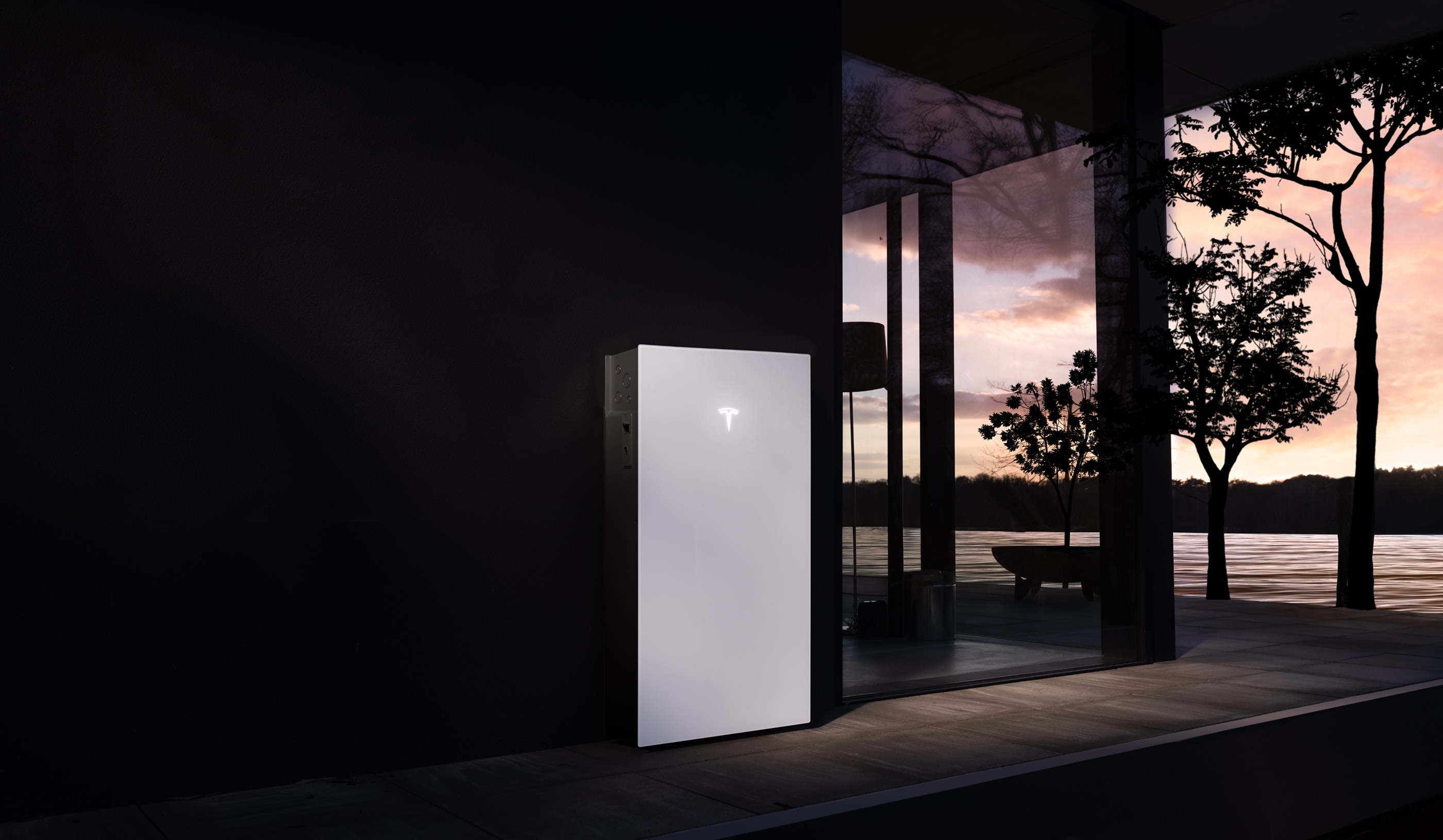 Powerwall 3 installed on the exterior wall of a modern home at dusk